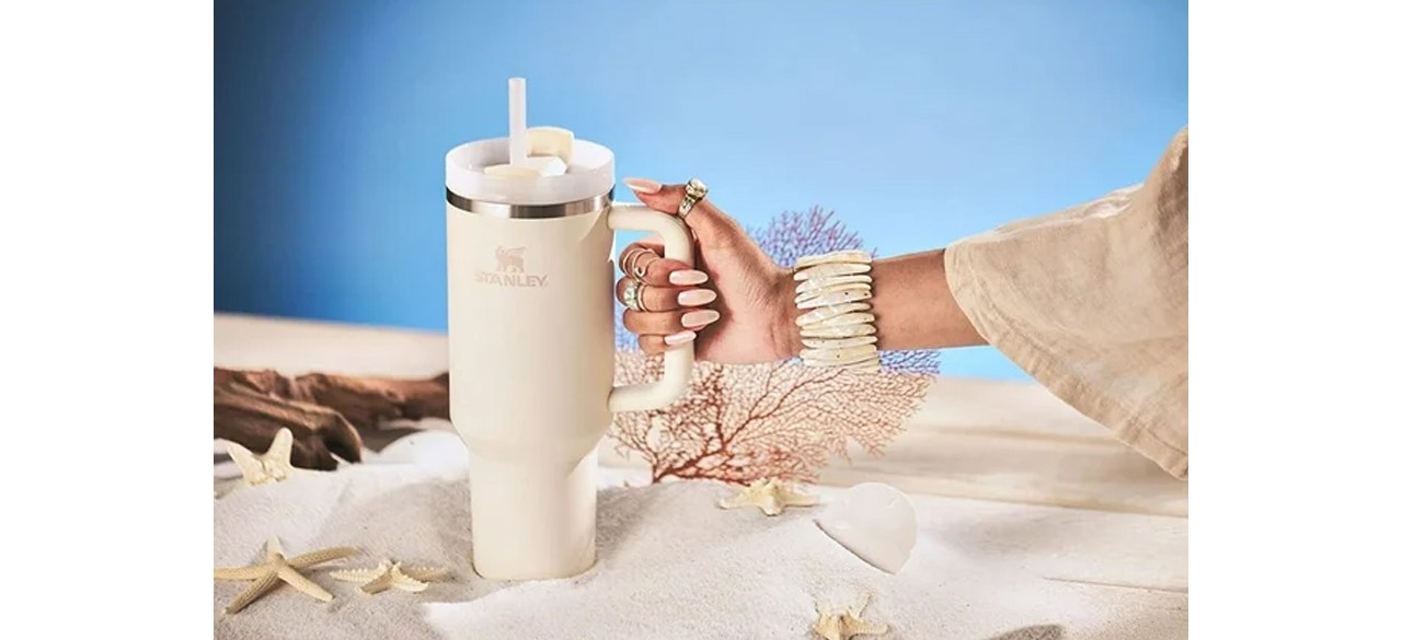 hand holding Stanley Quencher H2.0 FlowState Stainless Steel Vacuum-Insulated Tumbler with Lid and Straw
