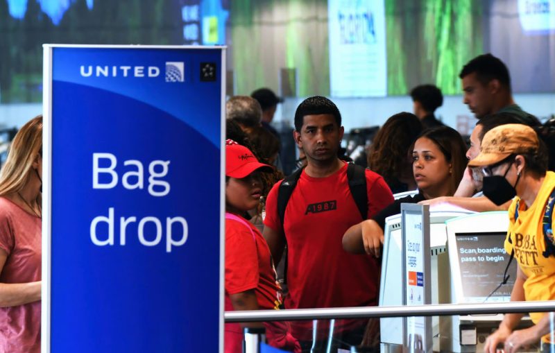 travelers at United Airlines bag drop