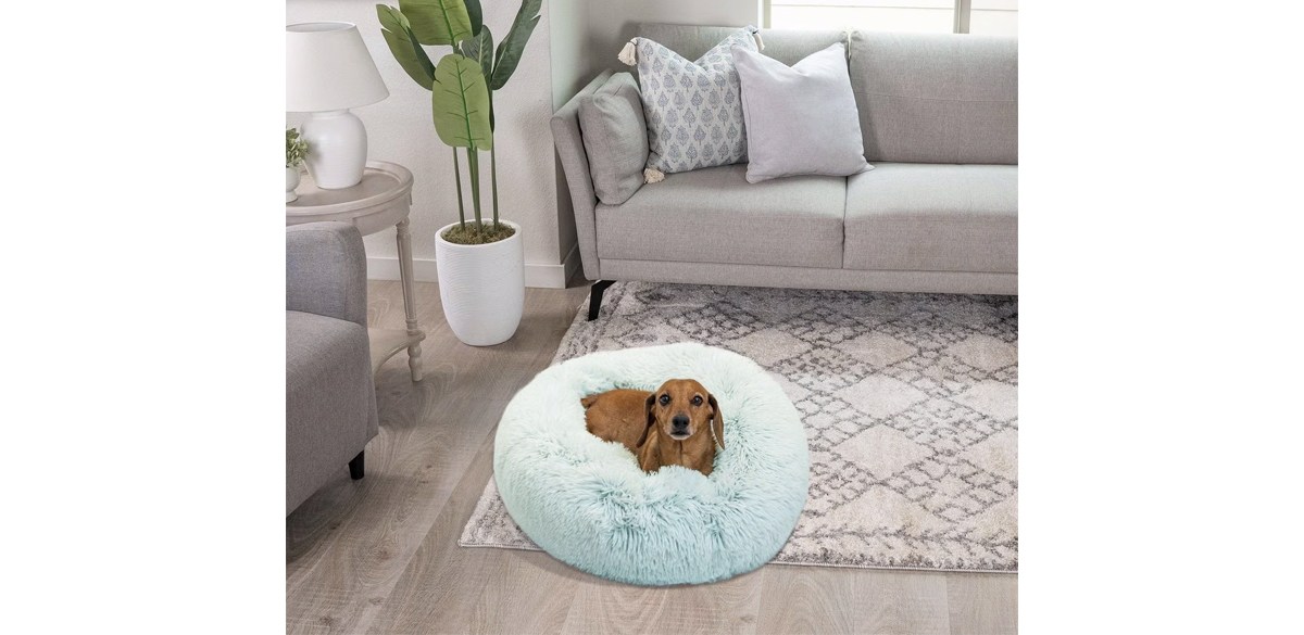 Dog laying on Friends By Sheri The Original Calming Shag Fur Donut Cuddler