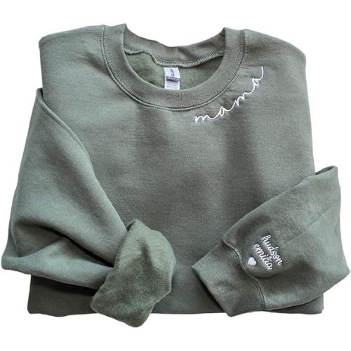 green pullover with white embroidery