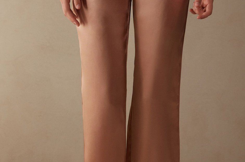 model wearing brown silk pajama pants