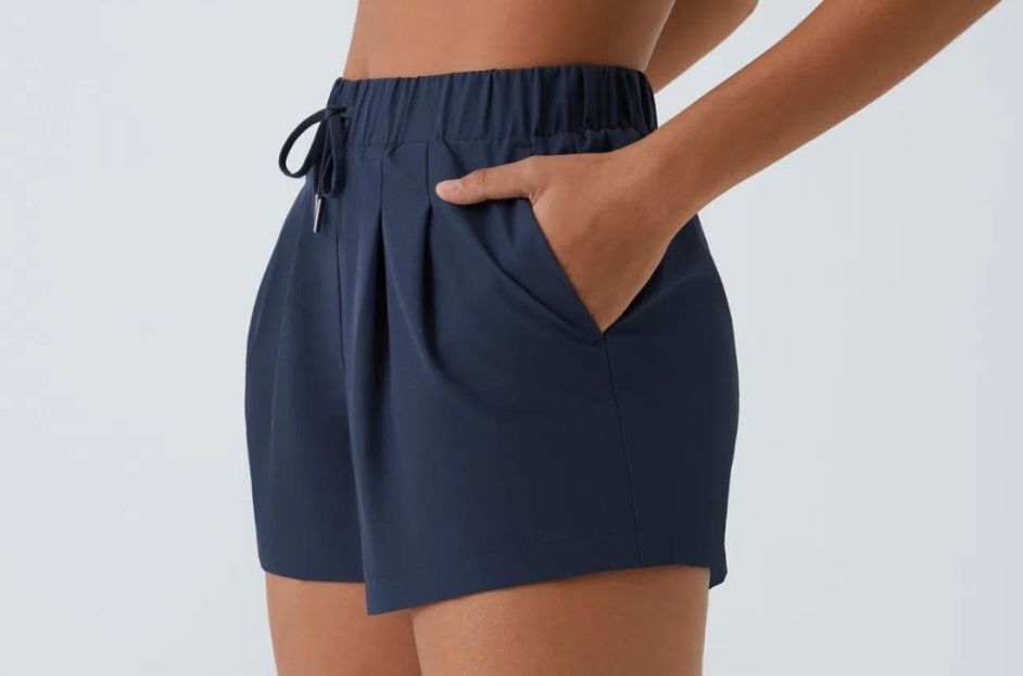 model wearing navy blue shorts with matching sports bra