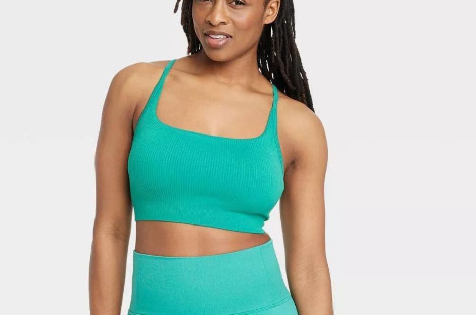 model wearing sleeveless green ribbed sports bra