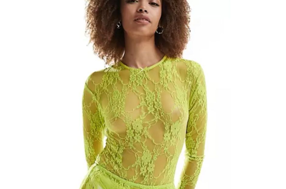 model wearing mesh lace neon green bodysuit and silver purse
