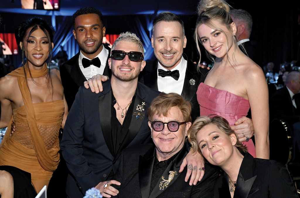 Elton John and David Furnish with party attendees (clockwise, from left) Michaela Jaé Rodriguez, Lucien Laviscount, Andrew Watt, Charlotte Lawrence and Brandi Carlile.