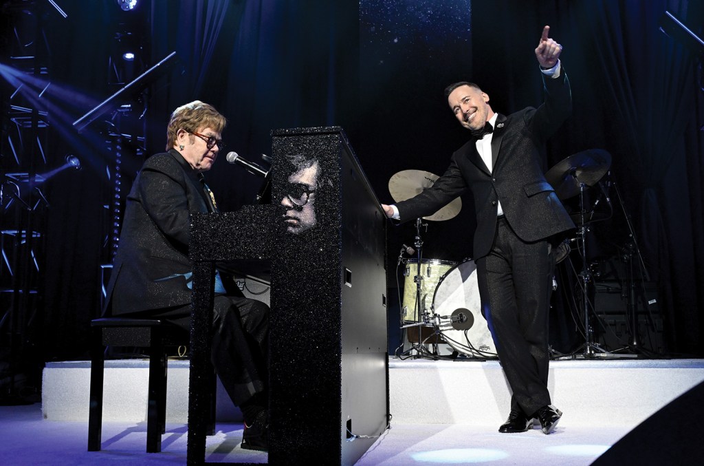 Elton John (left) and David Furnish onstage at the Elton John AIDS Foundation’s annual Academy Awards Viewing Party in March.