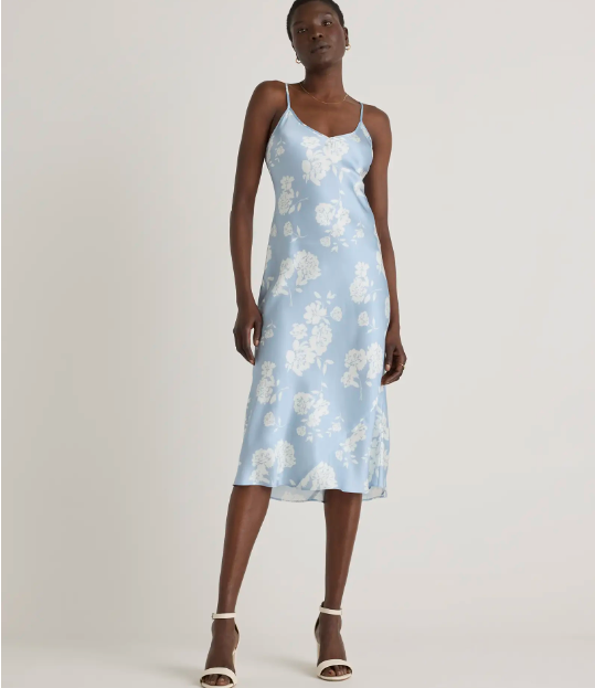model wearing blue and white floral satin midi slip dress