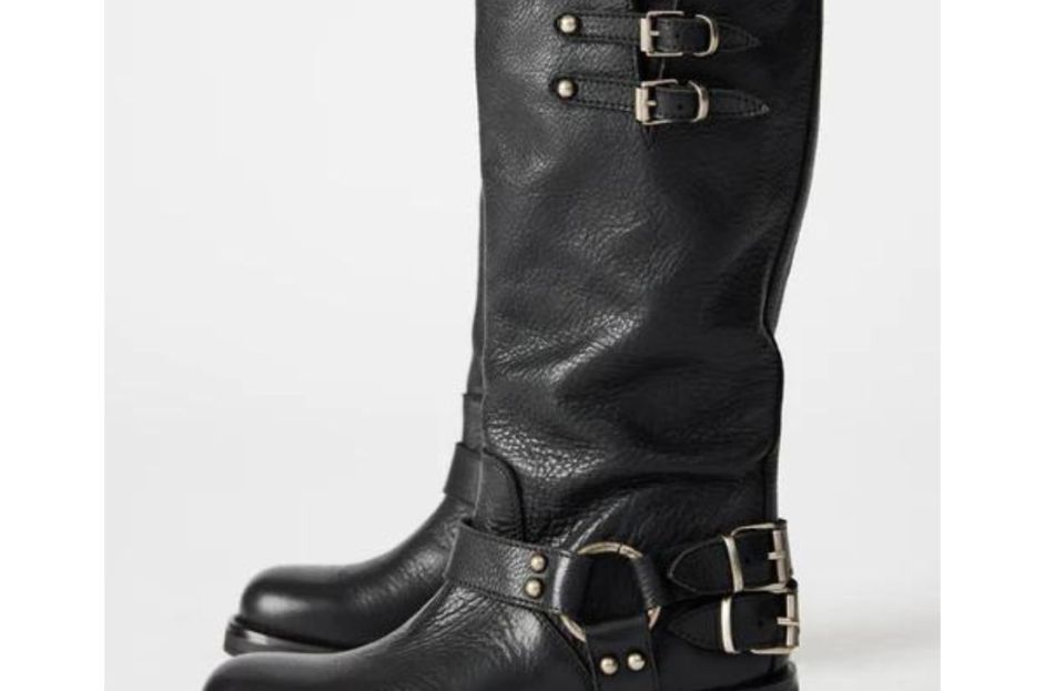 model wearing pleather black steve madden boots with buckles