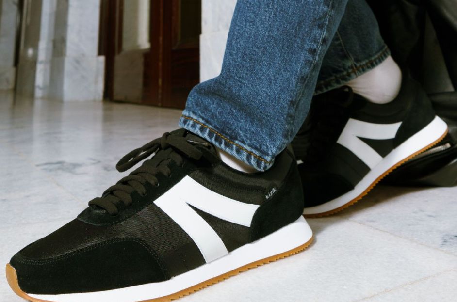 model wearing black and white kizik sneakers
