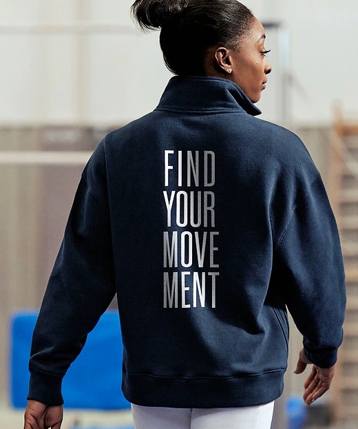 simone biles wearing navy graphic athleta sweatshirt