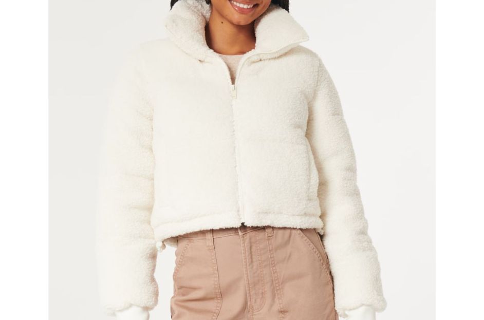 model wearing sherpa white puffy jacket with brown pants