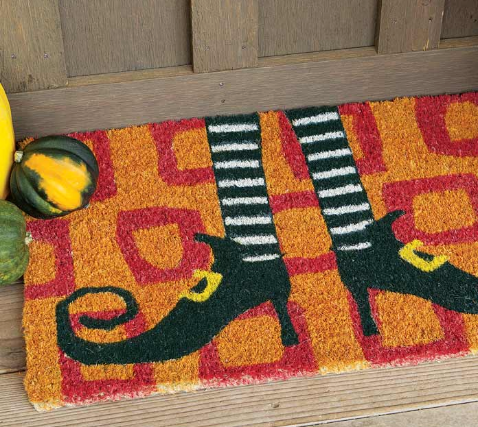 orange and red doormat with witches legs