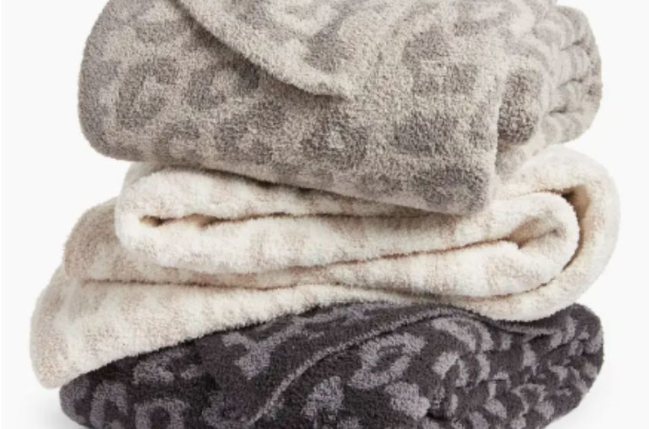 stack of grey, cream and black barefoot dreams leopard print blankets