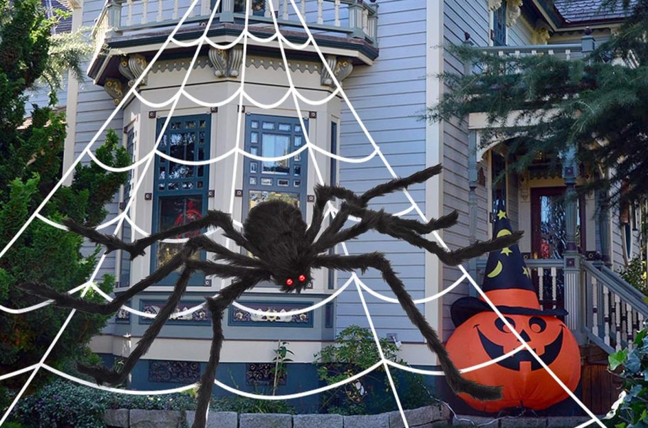 giant fake spider and web in front of house
