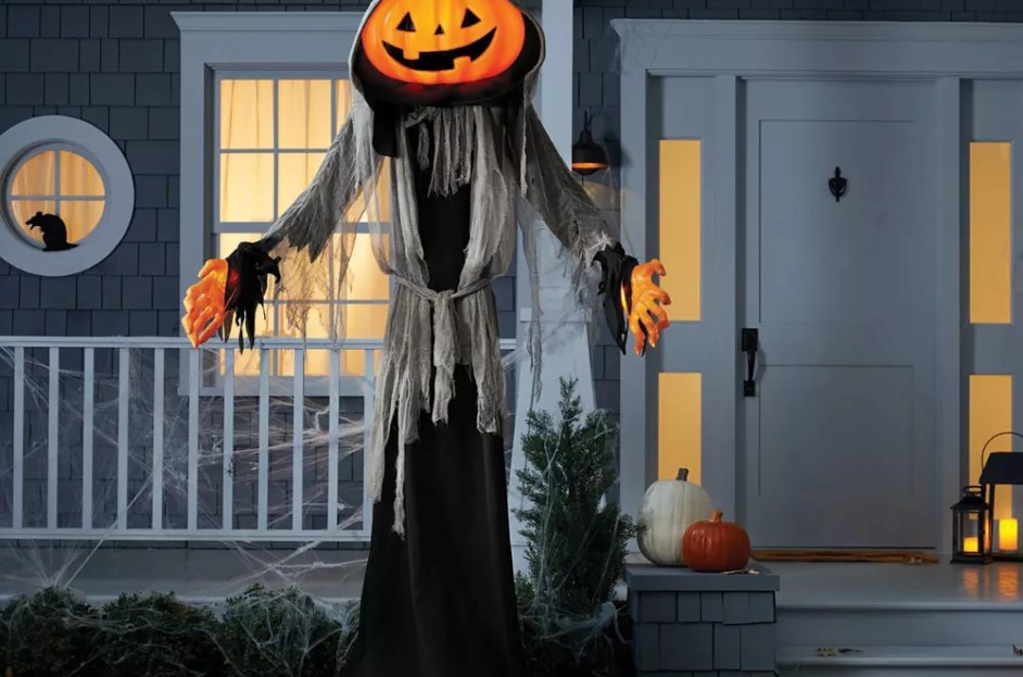 giant pumpkin in cloak statue on front yard
