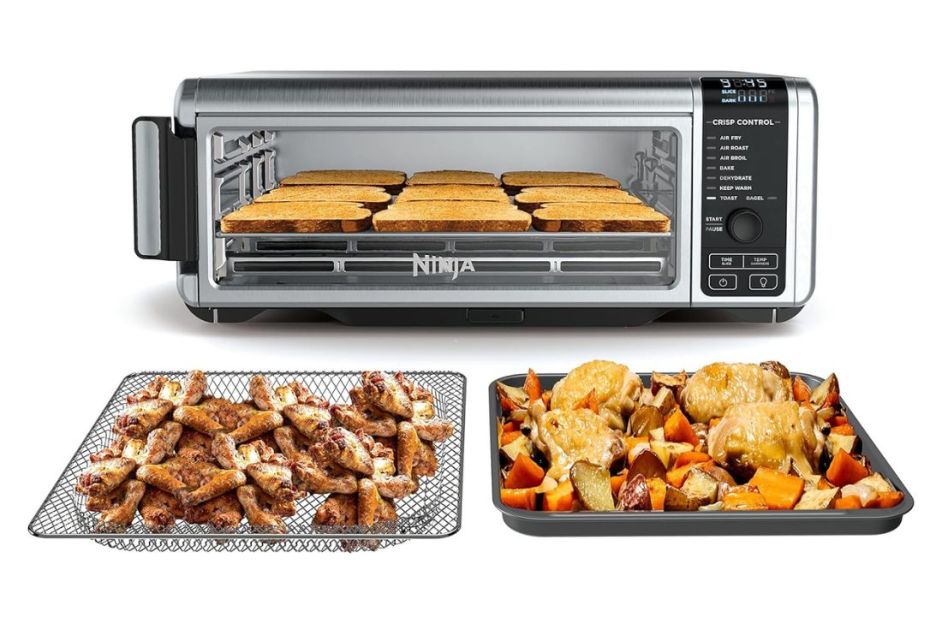 black and silver ninja air fryer with food on trays