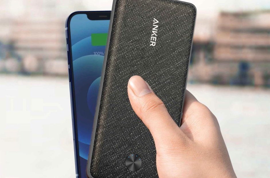 model holding portable charger over smartphone