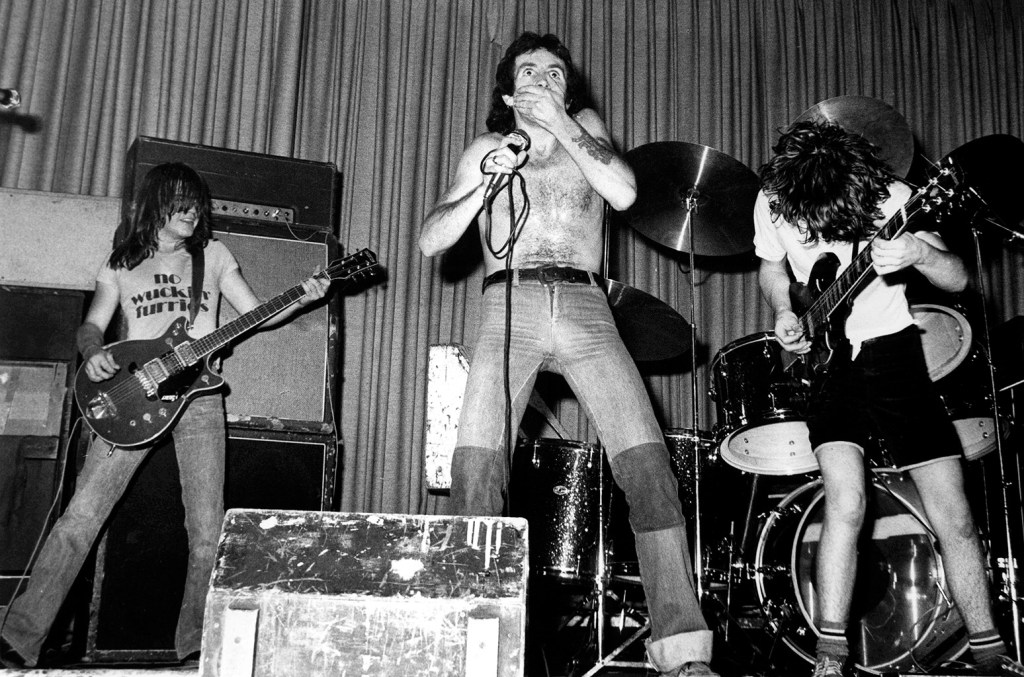 Malcolm Young, Bon Scott, and Angus Young of AC/DC performing at The Nashville Rooms on April 26, 1976 in London.