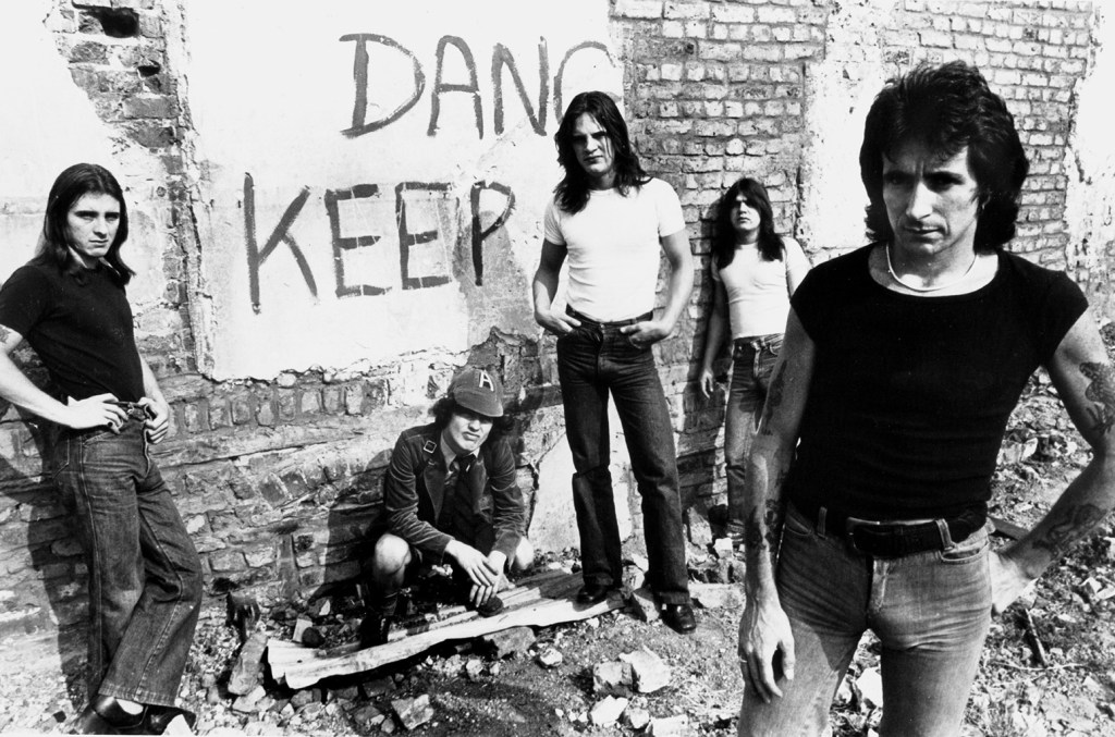 Phillip Rudd, Angus Young, Mark Evans, Malcolm Young, and Bon Scott of AC/DC pose for an Atlantic Records publicity still in front of a graffiti-covered wall circa 1977.