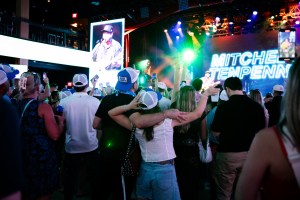 Attendees in Bud Light hats watching Mitchell Tenpenny perform at Billboard Country Live