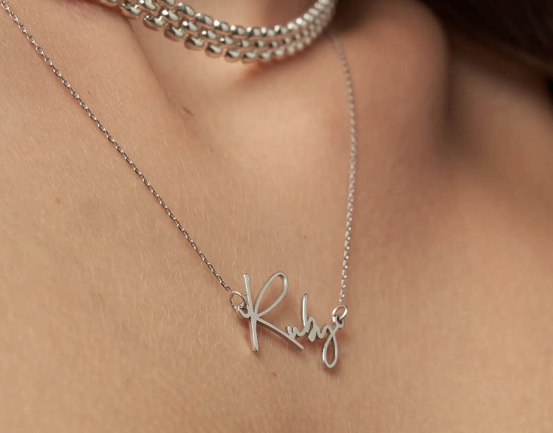model wearing silver nameplate neckalce