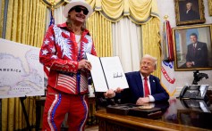 U.S. President Donald Trump, accompanied by entertainer Kid Rock, signs an executive order in the Oval Office of the White House on March 31, 2025 in Washington, DC.