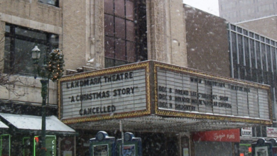Snowy street view of the Landmark Theatre marquee reading 'A Christmas Story Cancelled'.