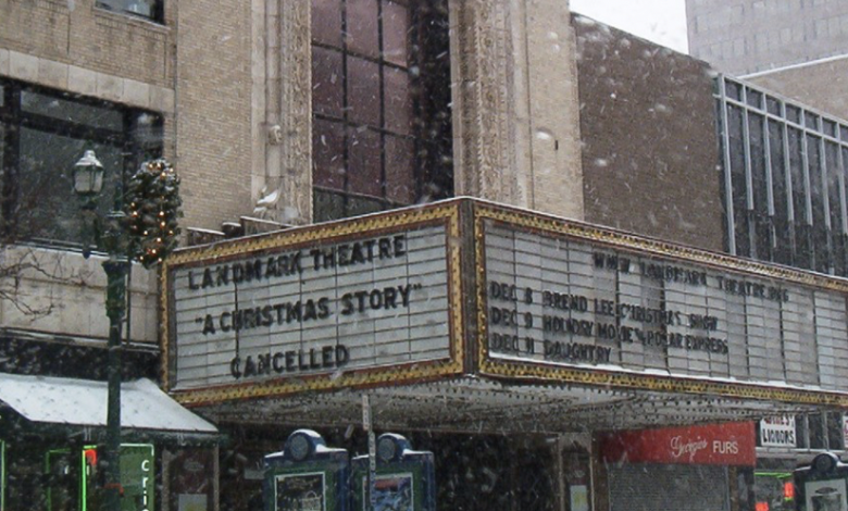 Snowy street view of the Landmark Theatre marquee reading 'A Christmas Story Cancelled'.